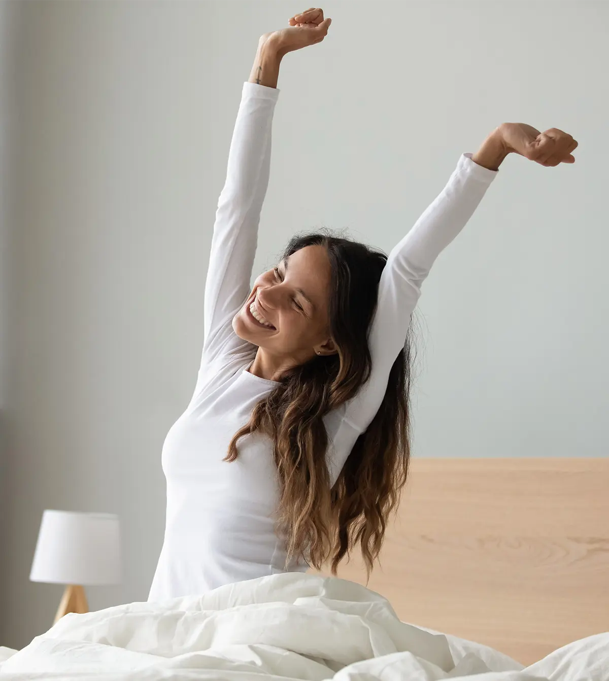 Woman waking up feeling refreshed